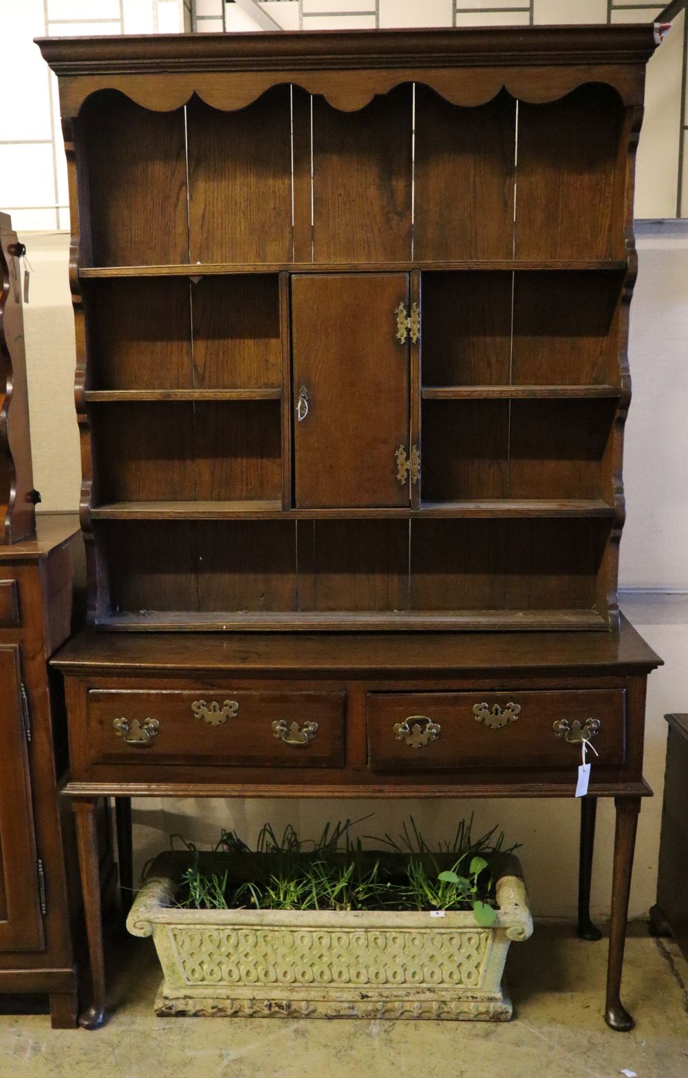 An 18th century oak low dresser with later boarded plate rack, width 128cm depth 46cm height 216cm